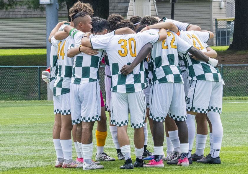 MCCC Men's Soccer Team in a huddle