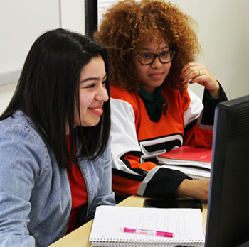 Two female students working at computers