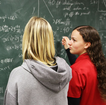 Two female students calculating math problems